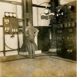 Electrician at Diesel Generator Board, Man and Supply 