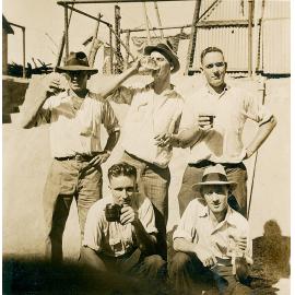 Group of men having beer at The Isa Hotel
