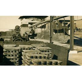 Loading lead ingots into railway wagon with electric lead buggy, Lead Smelter 