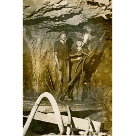 Two men at work on a machine, Mount Isa Mines