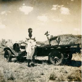 Man after a swim & dog on a truck