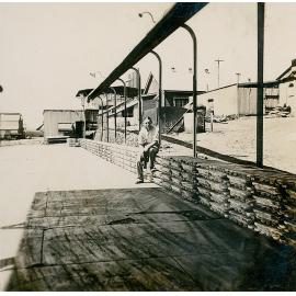 Norm Nancarrow sitting on lead ingots ready for transport to Townsville
