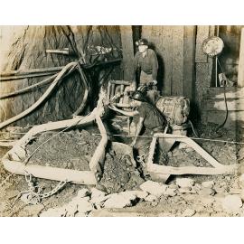 Miners scraping ore with slusher at 8 Level, Black Star, Mount Isa Mines