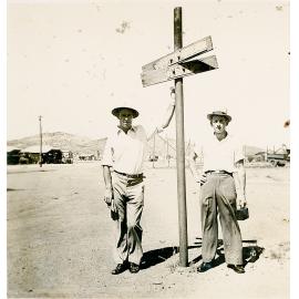 Two men at the Cloncurry and Camooweal sign, Mount Isa City