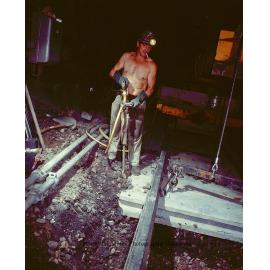 Workers laying concrete sleepers for underground haulage railway, Mount Isa Mines, March 1975