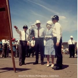 Queen Elizabeth II and Prince Philip view photograph of underground haulage operations, Mount Isa Mines, April 1970