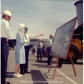 Queen Elizabeth II and Prince Philip view photograph of mine operations, Mount Isa Mines, April 1970