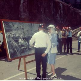 Queen Elizabeth II views photograph of underground drilling, Mount Isa Mines, April 1970