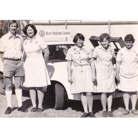 Blue Nursing Service staff in front of car