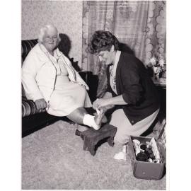Blue Nursing Service Nurse providing assistance