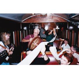 Musicians and passengers on train, c.1998