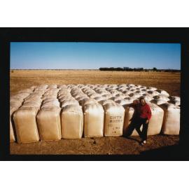 Edith Downs Station worker stands next to bagged material