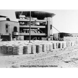 Stacked lead bars waiting for railway transport to Townsville, November 1963