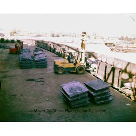 Loading copper into railway wagons at Copper Smelter, Mount Isa Mines