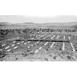 Train passing through tent city