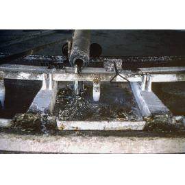 Pouring molten lead into casting wheel moulds at Lead Smelter, Mount Isa Mines, July 1956