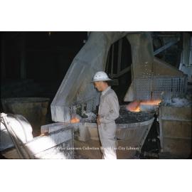 Separating slag from molten lead from the furnace at Lead Smelter, Mount Isa Mines, July 1956