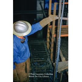 Worker checking thickeners level at Mill, Mount Isa Mines, July 1956